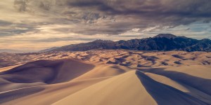 A view of the sand dunes and Sangre de Cristo mountains at sunset in the Great Sand Dunes National Park, Colorado USA